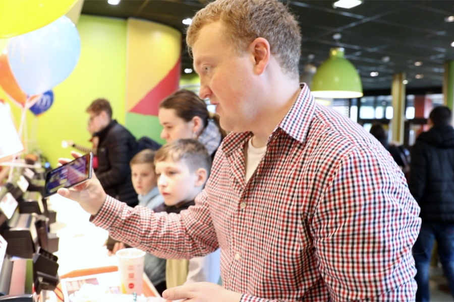 A McDonald's customer using the Duda Belarusian cultural activation in a restaurant